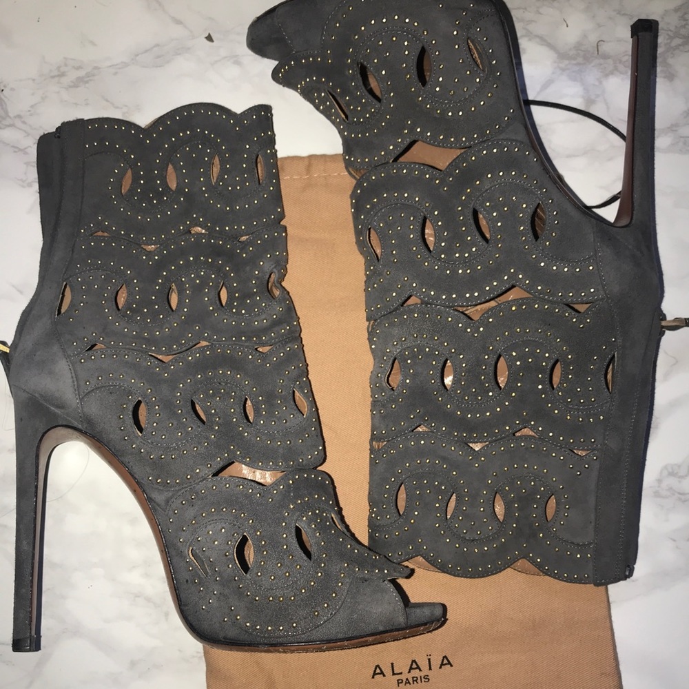 ALAÏA PARIS GOLD STUDDED ANKLE BOOTIES